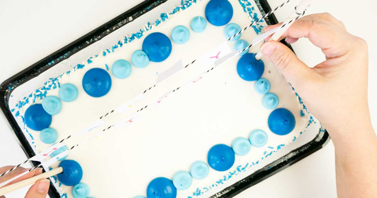DIY birthday banner tutorial: Press the dowels into the cake