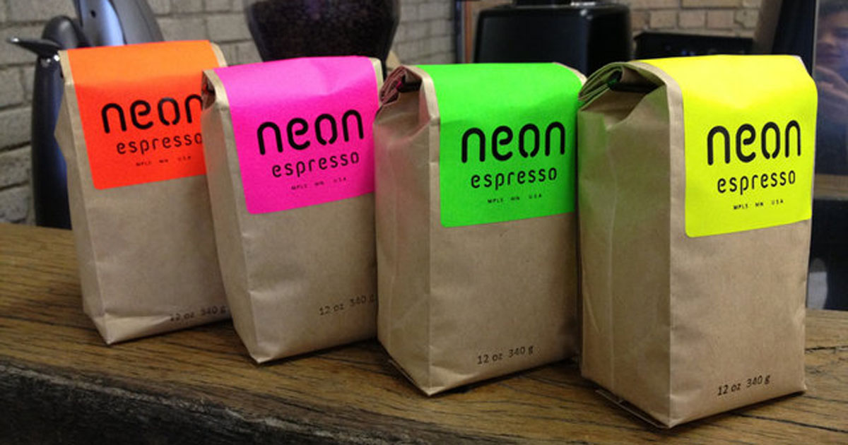 Brown paper coffee bags sealed with neon product labels in various colors to distinguish different flavors/brews