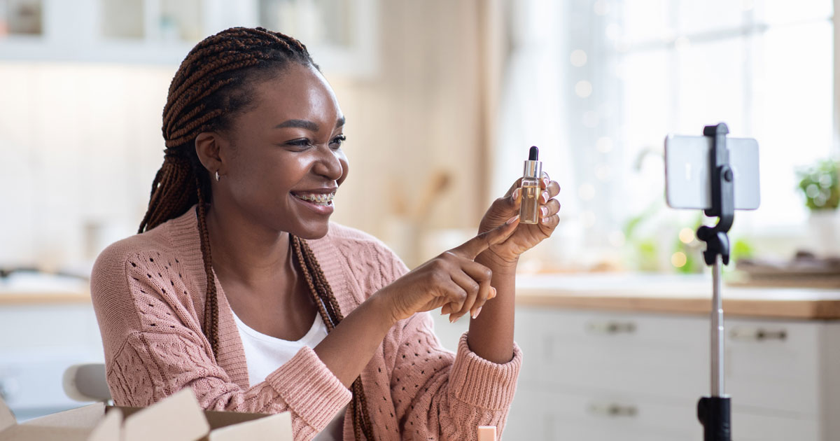 Social media influencer showing a product to the camera.