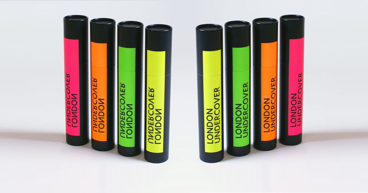 Black tubes to hold umbrellas with neon-colored product labels
