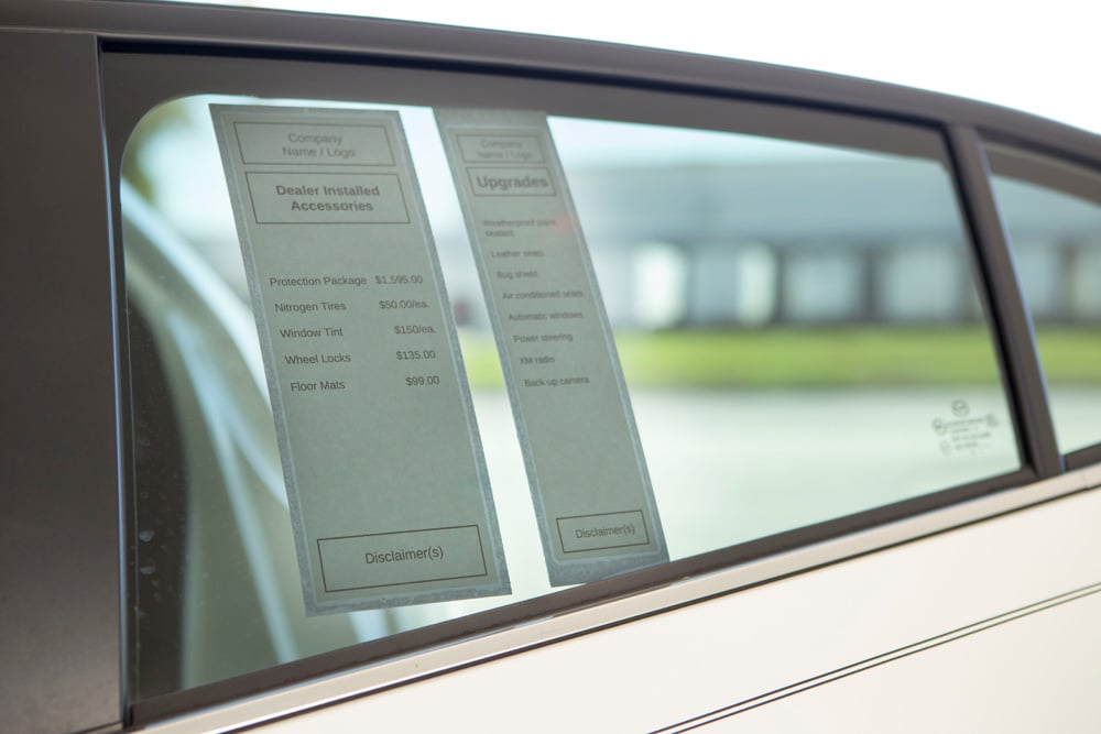 Addendum size car dealer window stickers on car window
