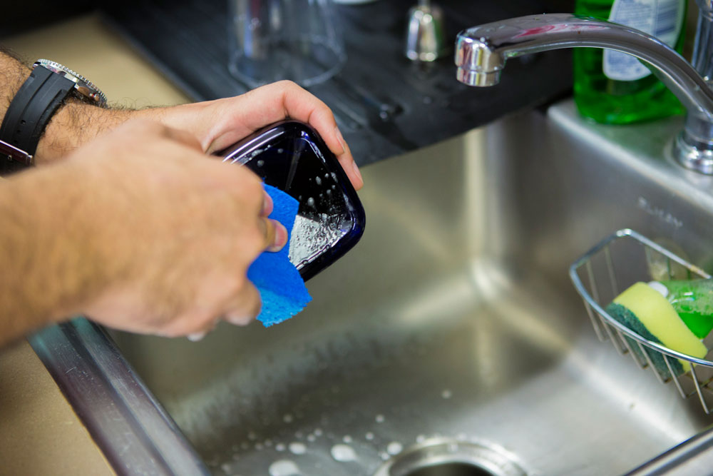 Scrubbing residue off of plastic container.