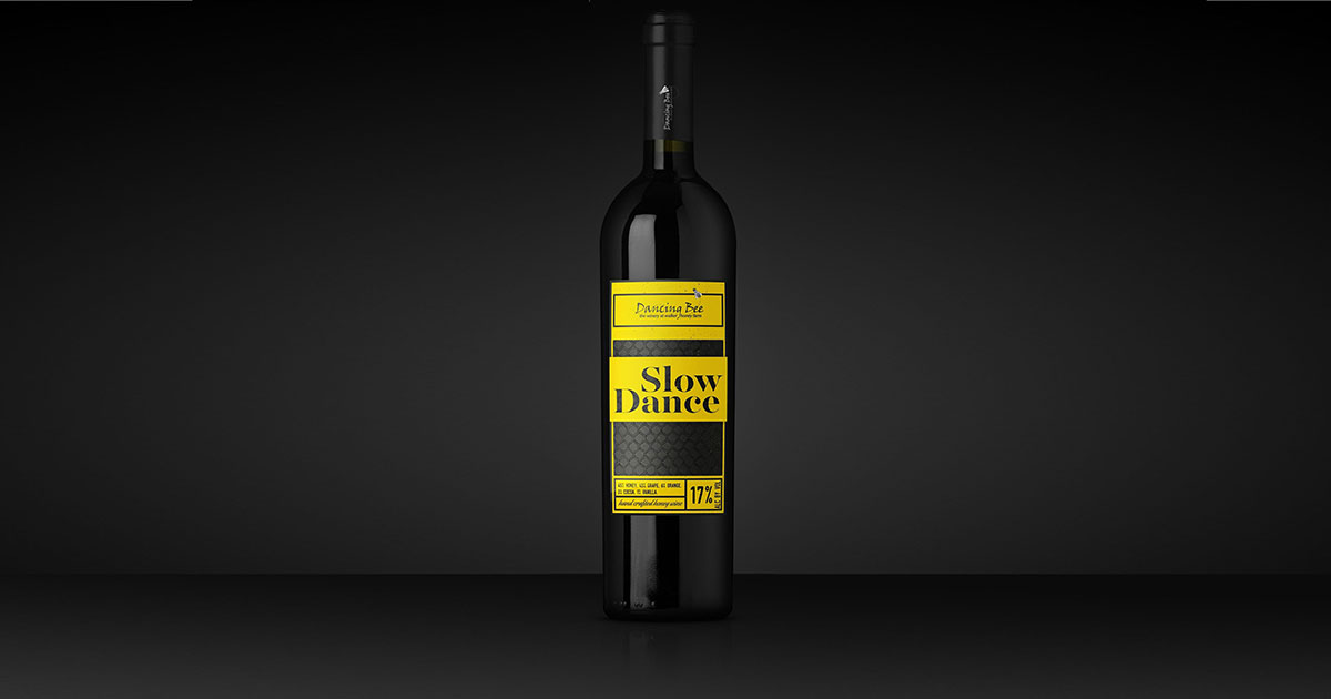 Black glass wine bottle label with a neon yellow product label